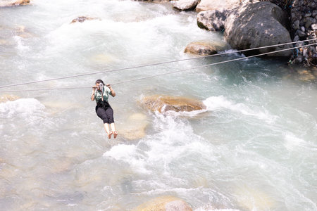 girl is riding zipline trolley