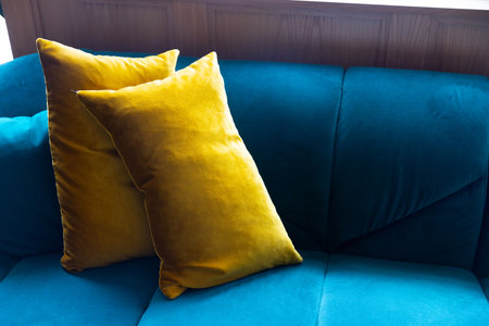 The home or apartment interior is decorated with a blue sofa and yellow pillows. Scandinavian homeの写真素材