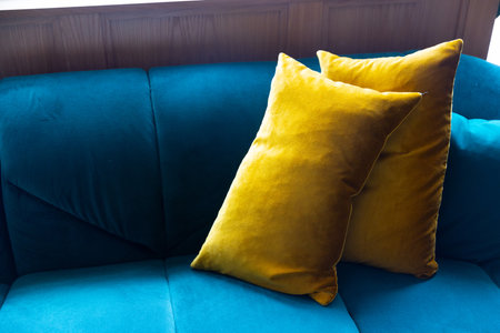 The home or apartment interior is decorated with a blue sofa and yellow pillows. Scandinavian home interior design of modern living room. Indoors real photo.の写真素材