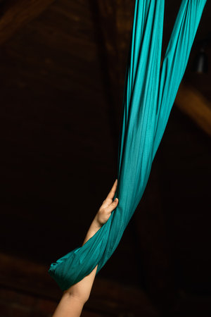 Training on a hammock with a beautiful girl. Fly yoga in the gym. Aero yoga.の写真素材