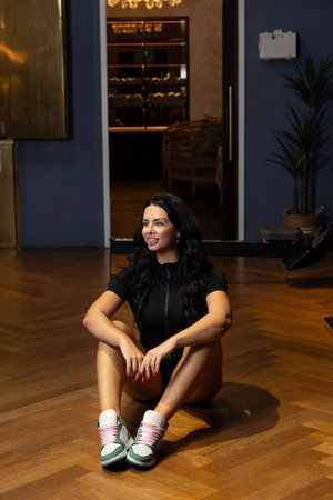 A girl is doing stretching exercises in the gym.の写真素材