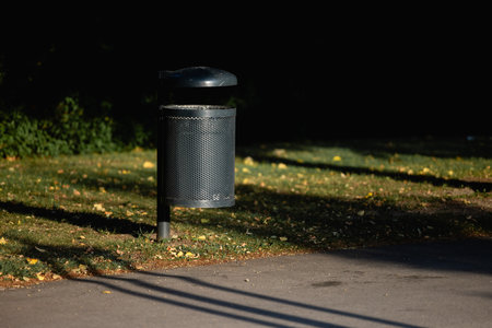 Empty trash can, street, metal, garbage bag, white, green, park, cityの写真素材