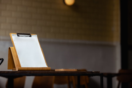 On the table there is a wooden stand with a tablet.の写真素材