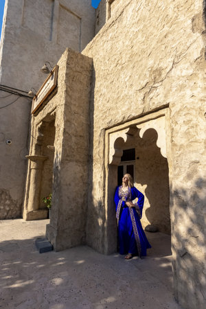 A European woman in an Arab national costume in old city Dubaiの写真素材