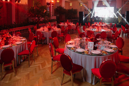 luxurious wedding table for guests creates an elegant ambiance through beautiful table setting. A table setting in redの写真素材