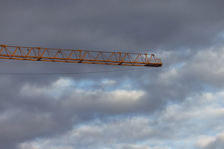 Construction crane against the sky in the process of working on a constructionの写真素材