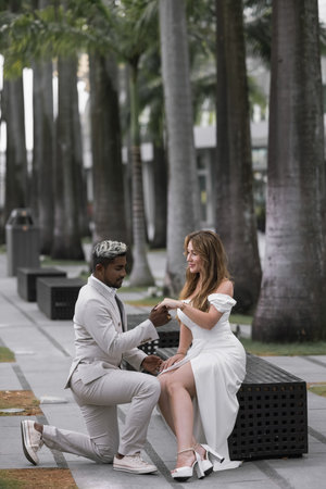 International wedding. The dark-skinned groom in a white suitの写真素材
