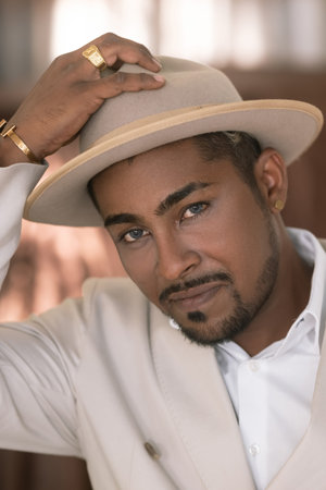 The groom in a hat. Portrait of the groom close up. The wedding. The groom in the white hat turned...