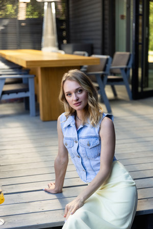 blonde woman in a blue denim vestの写真素材