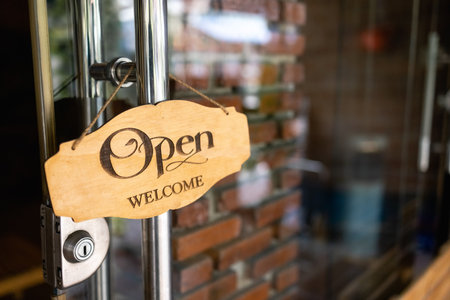 The text on the old wooden sign is open in the cafe and restaurant.の写真素材