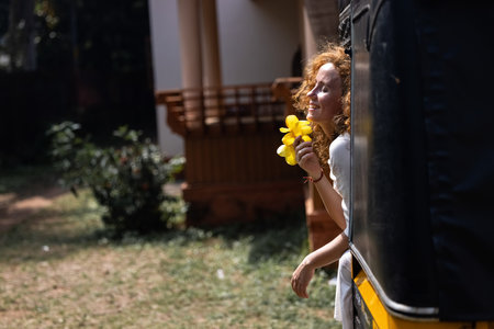 The wind blows through the brightly red hair of an attractive beautiful girlの写真素材