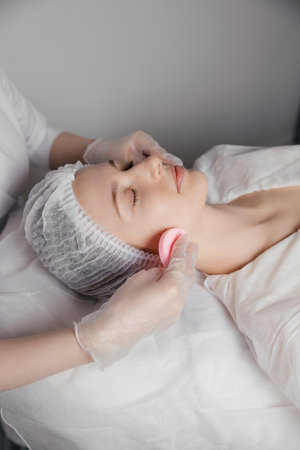 The doctor is performing a cosmetic procedure on the client.の写真素材