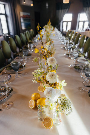 Event decor with white orchids and other white flowers in a restaurant.