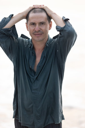 The man has hair after a hair transplant operation on his head. He is showingの写真素材