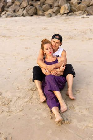 A couple in love embrace on the beach during vacation. There is love between the people.の写真素材