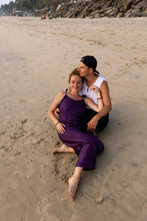 A couple in love embrace on the beach during vacation. There is love between the people.の写真素材