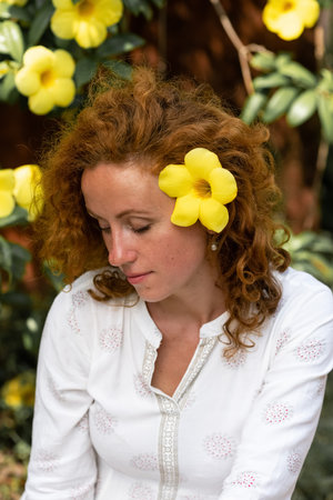 This portrait depicts a stunningly beautiful young woman with fiery red hairの写真素材