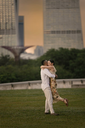 Close-up of an international couple embracing outdoors, stylish and emotional atmosphere.の写真素材