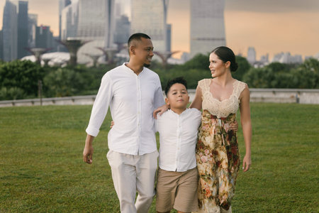 Happy international family of three enjoying time in Singapore. Asian father, Eastern European...