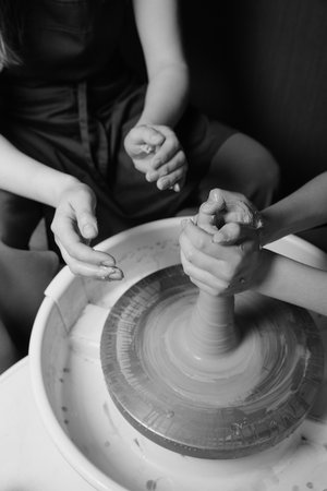 Close-up of hands shaping clay on pottery wheel in studio Creative ceramic art and mindful craftの写真素材