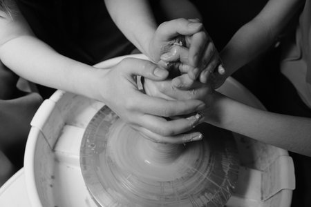 Close-up of hands shaping clay on pottery wheel in studio Creative ceramic art and mindful craftの写真素材