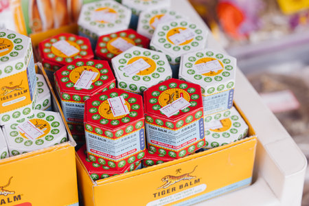 Singapore, July 3, 2025: Tiger balm ointment displayed on supermarket shelf popular in Asia providing relief for muscles headaches and other ailments perfect for health wellness and lifestyle projectsのeditorial素材