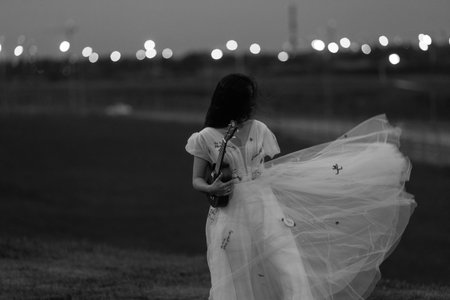bride in a wedding dress plays the Ukulele a Hawaiian fourstringed guitar