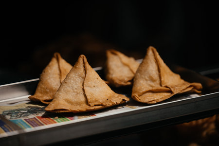 Traditional Indian cooking process of fried samosa popular street food