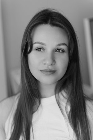 Black and white close up portrait of young Caucasian brunette woman