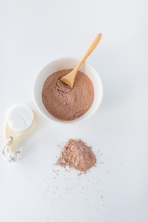 Moroccan red clay powder and facial brush. Home skin care concept. Minimal composition. Fashion and beauty blog.の写真素材