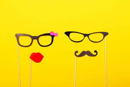 Male and female photo booth props on the yellow background. Wedding, party or Birthday concept. Flat-lay, top view. Copy space for your text.の写真素材
