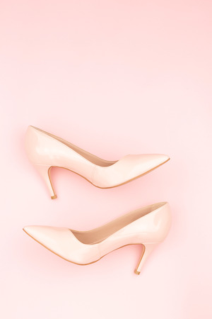 Classic nude court shoes on the pastel pink background. Flat-lay, top view. Copy space for your text.の写真素材
