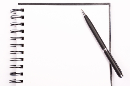 Notepad and a pen on white background. Open page. Stationery concept. Flat-lay, top view.の写真素材