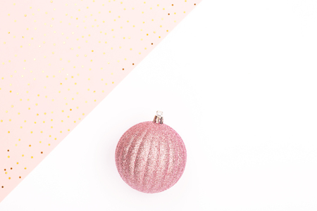 Christmas decor on white and pink combination background. Holiday and New Year concept. Copy space for text. Perfect for banners.の写真素材