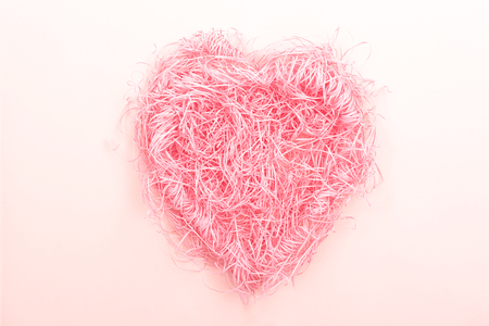 Heart shape nest made from shredded paper. Creative concept, minimal composition. Copy space for text.の写真素材