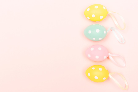 Easter eggs on pastel pink background. April holiday background. Flat lay, top view. Copy space for your text.の写真素材