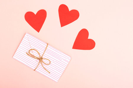 Creative love or Valentine day background made with cute envelope, heart shape paper and rope. Love...