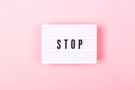 The lamp with letters STOP on pink background.の写真素材