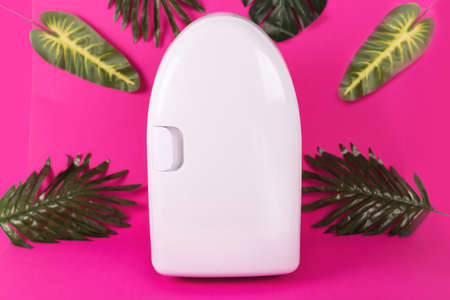 Mini fridge on vivid magenta background. Minimal composition.の写真素材