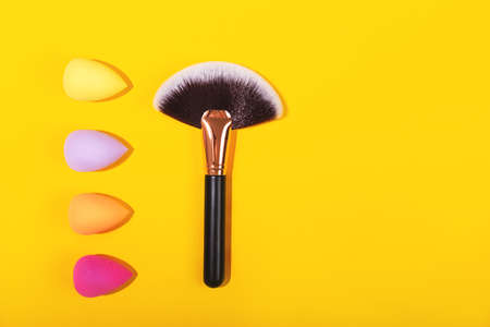 Colorful beauty sponges on bright yellow background.の写真素材