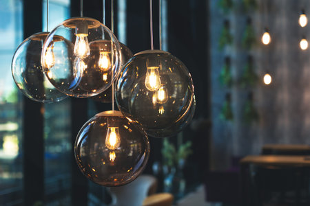 Cozy light bulbs in dark and moody cafe.
