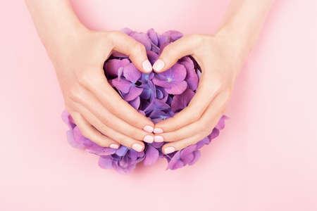 Woman hands with perfect pastel pink manicure.の写真素材