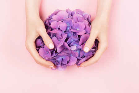 Woman hands with perfect pastel pink manicure.