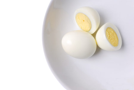Cooked peeled eggs in a white plate