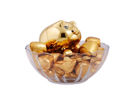 Gold pigs, ingots, coins isolated on a white backgroundの写真素材