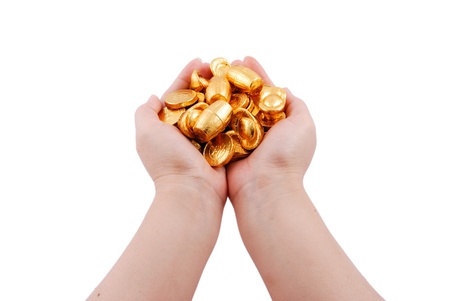 Closeup of hands holding gold coinsの写真素材