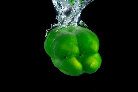 Pepper fruit into the water the momentの写真素材