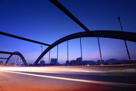 highway bridge at night with traces of light trafficの写真素材