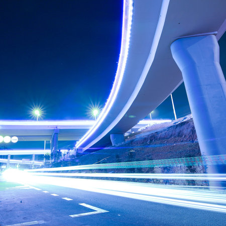 Viaduct car traveling light trails at night