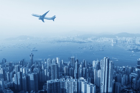 hongkong's skyscrapers and airplanes on skyの写真素材